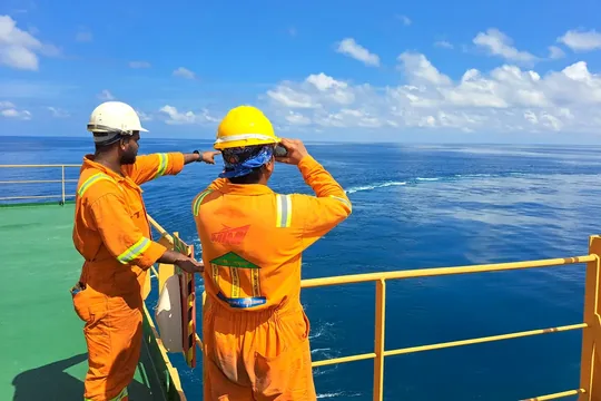 Representative image of marine professionals carrying out a deck-side technical inspection.
